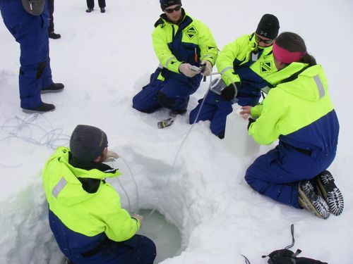 The Ice Team at work collecting salt water from inside the sea ice