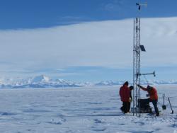 The team raises meteorological instrument equipment onto the Sabrina Automatic Weather Station (AWS), Antarctica.