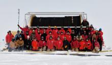 The whole IceCube team poses for a picture by the drill hose.