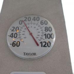 Thermometer in parking lot showing outside temperature