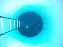 The only way below the ice is through one of these 4ft (1.3m) diameter boreholes. McMurdo Station, Antarctica.