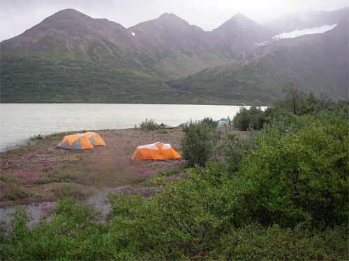 Three sleeping tents far away from the cook tent