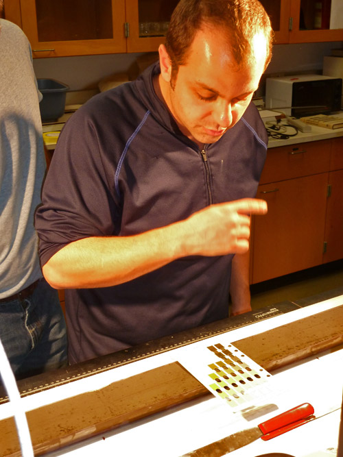 Brian using Munsell color cards to characterize sediment color