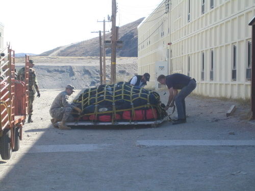 Members of the guard strapping down the pallet of luggage