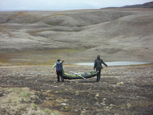 Carrying a boat across the arctic tundra.