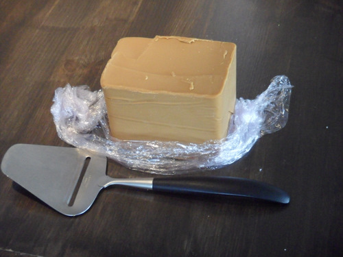 Brown cheese and cheese slicer.