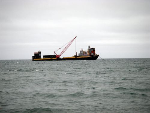 Container Barge Anchored Off Shore