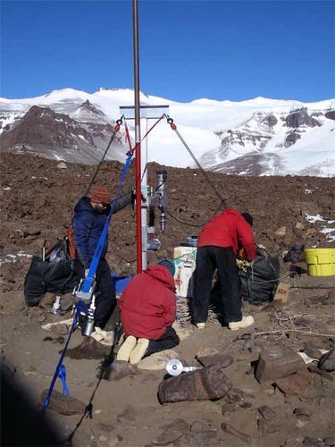 Drillers examine hole at site 3