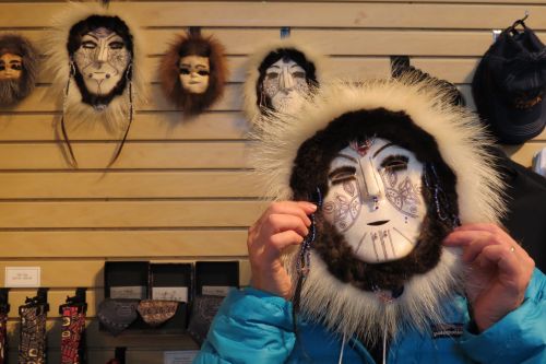 Lisa Seff wearing a mask by artist Dora Mae Buchea &quot;Umara Nupuwhotuk&quot; at the Museum of the North at the University of Alaska Faribanks.