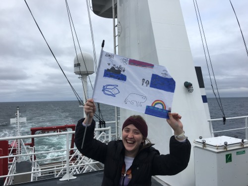 Arctic organism artwork flag from students at the Anvil City Science Academy in Nome Alaska! Celebrity flag holder Jenny Stern! Photo by Lisa Seff.  August 2017.