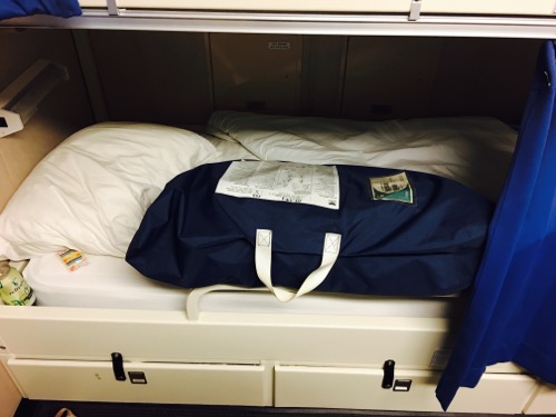 No lee cloths? No problem! Lee cloths are often found on boats bunks.  Their a cloth attached underneath the mattress that you can tie up in bad weather to keep you from rolling out of bed.  There was no lee cloth so I used the immersion suit and bag instead.  September 6, 2017.  Photo by Lisa Seff.