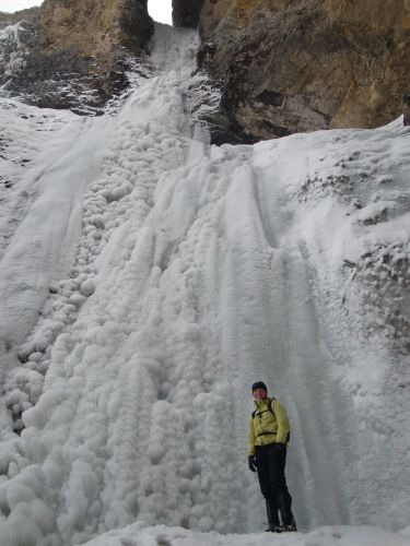 Melissa standing by the frozen waterfall
