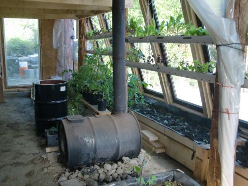 The greenhouse is heated by a wood stove.
