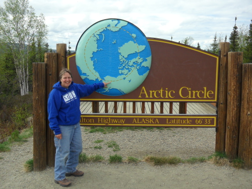 Ms. Steiner at the Arctic Circle sign, milepost 115 along the Dalton Highway