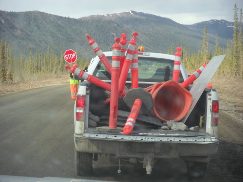 DOT pickup truck filled with road route markers, sign holder almost hidden in fr