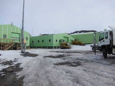 lime-green houses and yellow vehicles