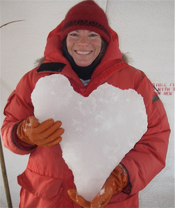 Mindy holding a chunk of heart-shaped ice they pulled out of a dive hole!