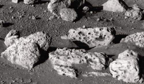 Photograph of pitted rocks on surface of Mars.