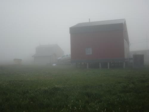 The bunkhouse, the truck and the previous bunkhouse in the thick fog.