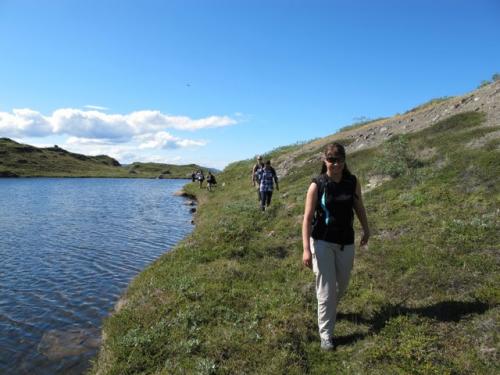 Christine leads the way along a ridgeline lake