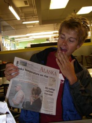 Caleb contemplates the newspaper