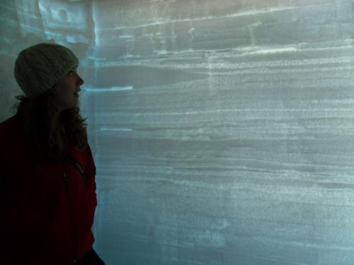 Kaitlin Keegan explaining snow layers in the backlit snowpit