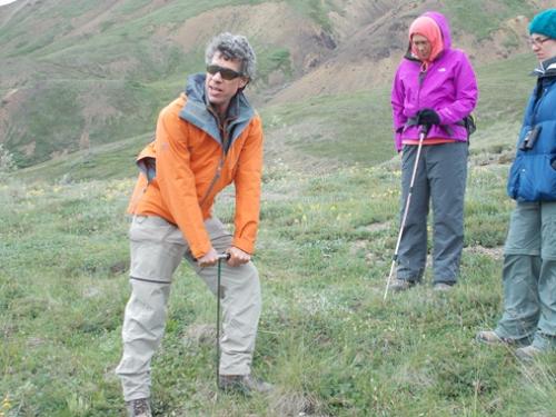 Dave Schirokauer demonstrating measuring permafrost depth