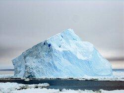 A sloped blue iceberg. Aboard the icebreaker Oden between the Amundsen and Ross seas. Photo by Lollie Garay.