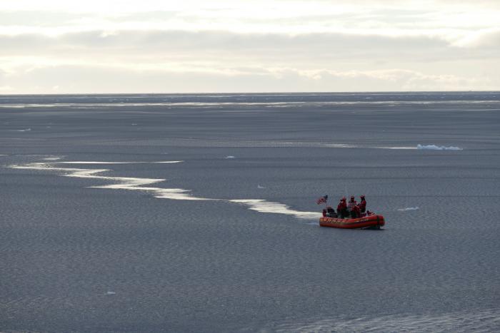 The small zodiac boat easily nudges its way through the pancake ice on its way back to the Healy. Aboard the USCGC Healy in the southern Canada Basin. 73.37°, -156.81°. Photo by Bill Schmoker (PolarTREC 2015), Courtesy of ARCUS.