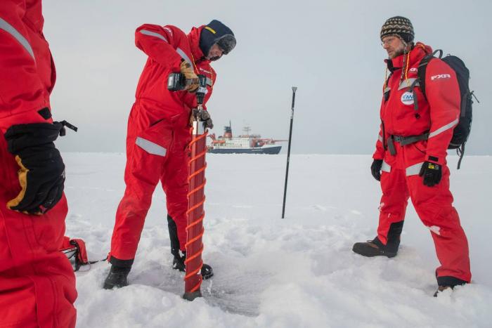First group of scientists lands on an ice floe. Gunnar Spreen (l) and Matthew Shupe (r) exam a potential ice floe for MOSAiC. September 30, 2019, Esther Horvath (Photo: Esther Horvath; Courtesy of AWI 2019.)
