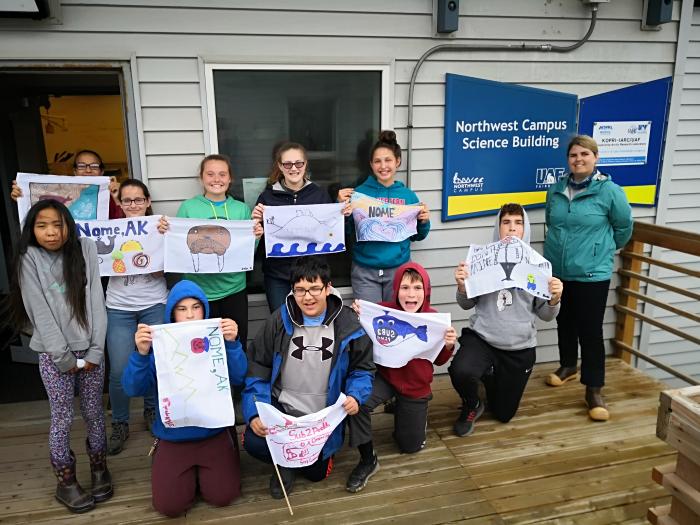 Group photo of the Ecology Explorers with their flags.