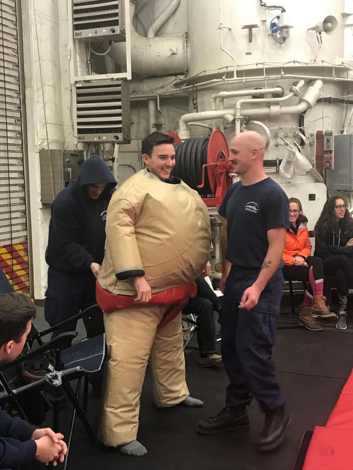 A member of the Coast guard getting into his sumo suit.