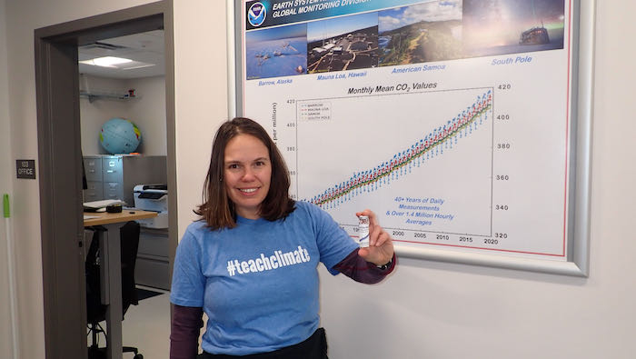 Sarah R. Johnson with freshly bottled air from the Barrow Atmospheric Baseline Observatory and labeled with current ppm of atmospheric carbon dioxide.  