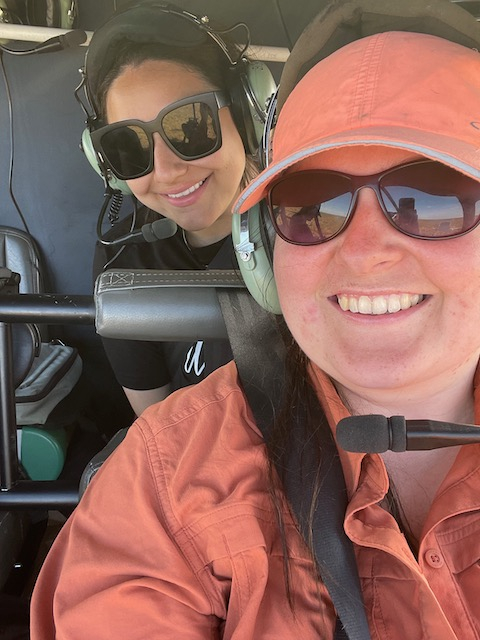 Lexy and Liza sit inside the helicopter. 