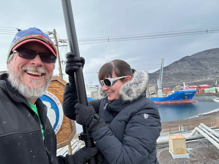 Bill Henske and Ariel Waldman using a 30 ft pole to take 360 photos of McMurdo