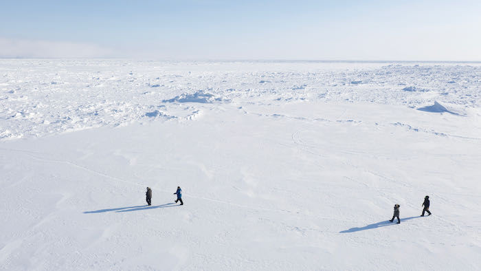 IABP team walking across Arctic Ocean sea ice just offshore of Barrow Point, Alaska. Photo by Ignatius Rigor.
