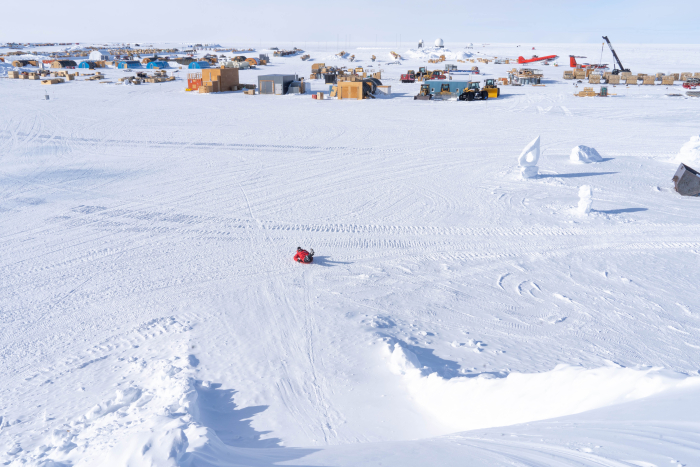 A person sledding in the storage yard at the South Pole Station
