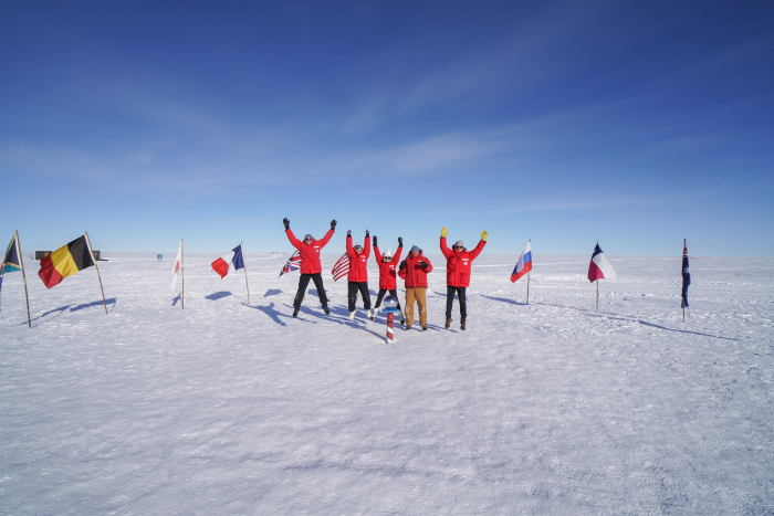 A group of people jumping at the South Pole