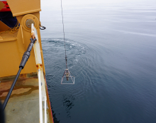 The benthic core is lowered into the Chukchi Sea from the back of the Healy.
