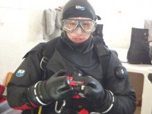 A diver in a mask and dry suit
