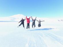 4 people jumping on the sea ice in Antarctica