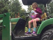 Daughter with a drawing on a tractor