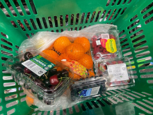A grocery basket filled with fruits