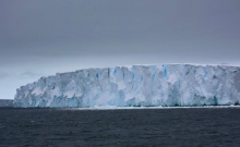 A towering iceberg alongside the R/V Nathaniel B. Palmer icebreaker in the Amundsen Sea