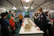 Researchers gather for a shift change meeting onboard the R/V Nathaniel B. Palmer icebreaker