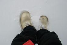 Boots sinking into the snow.