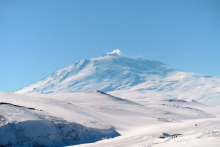 Zoomed-in view of Mt. Erebus with smoke arising from summit.