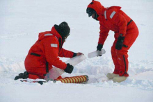 Kyle Dilliplaine and Carl Lamborg collect an ice core sample