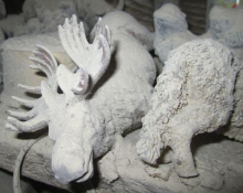 Hand carved moose covered in bone dust