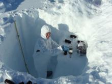 Scientist collecting clean snow samples